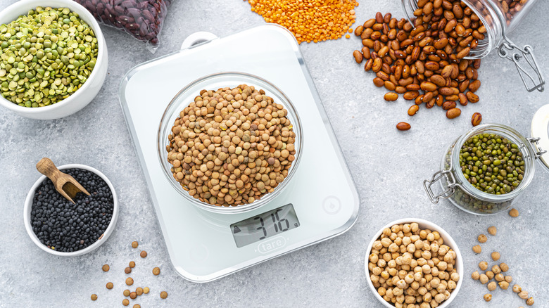 A kitchen scale measuring a bowl of lentils