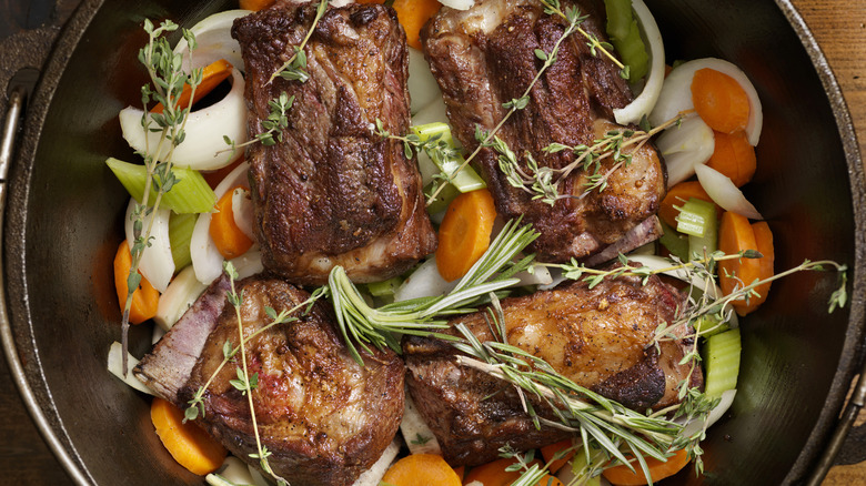 Braised short ribs being cooked in a dutch oven