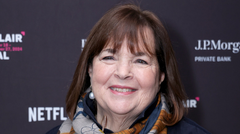 Ina Garten smiling in front of a step and repeat featuring J.P. Morgan, Netflix and more.