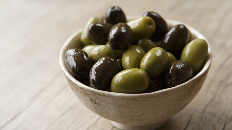 Black and green olives in small bowl