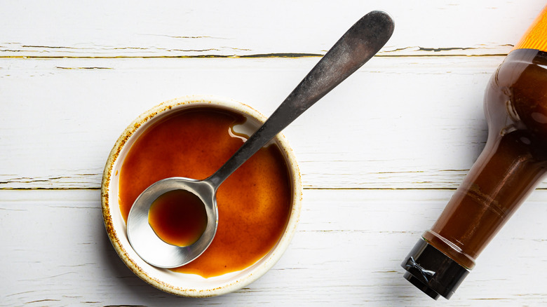 Worcestershire sauce in ramekin with spoon