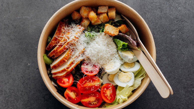 bowl of colorful salad ingredients on charcoal background