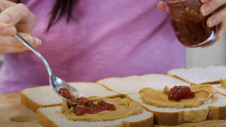 Making homemade peanut butter and jelly sandwiches