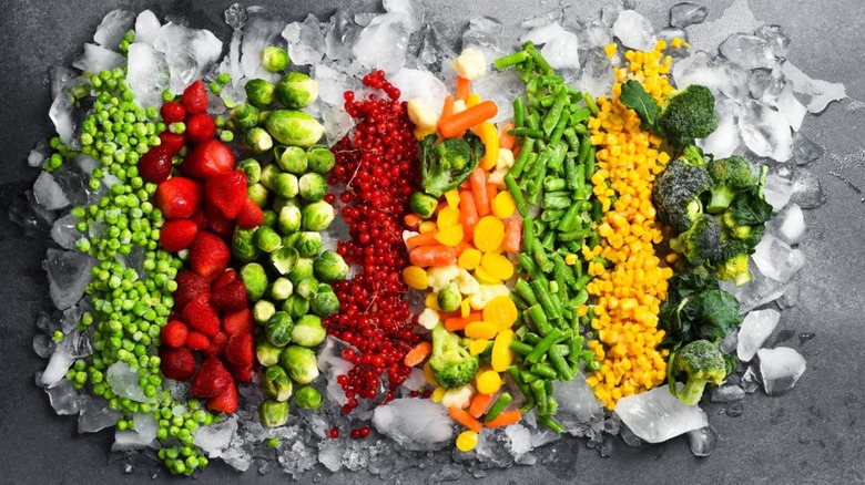 Various frozen fruit and veggies on bed of ice