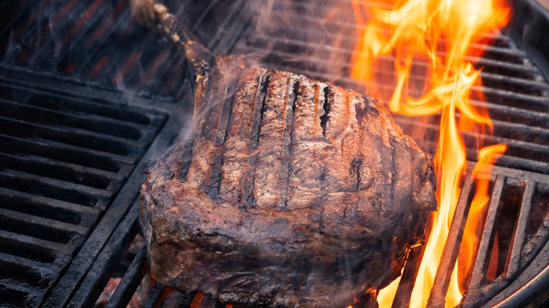 tomahawk steak on charcoal grill