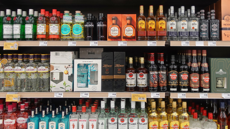 A variety of alcohol bottles stocked on a liquor store shelf