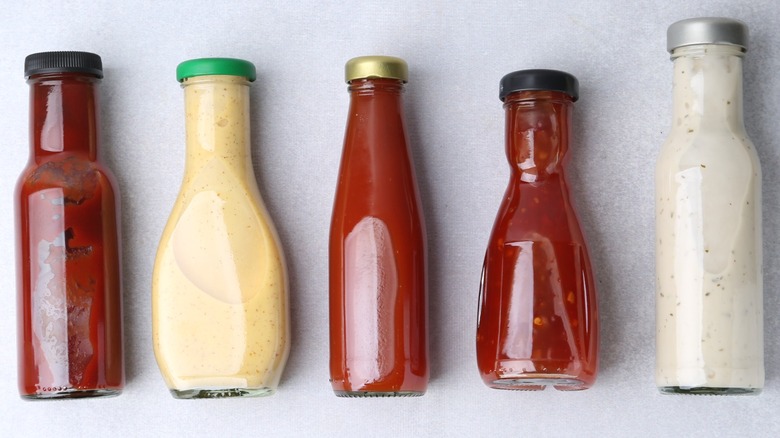 Various sauces and condiments in glass bottles