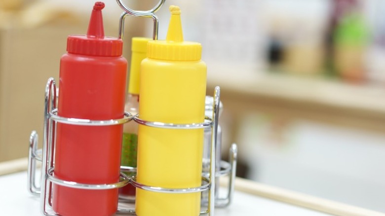 Bottles of ketchup and mustard on a diner table