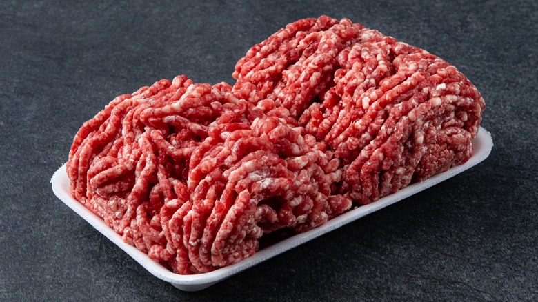 a styrofoam tray with ground beef on it