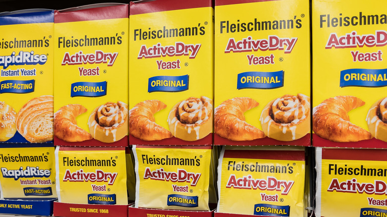 Boxes of Fleischmann's yeast sit stacked on top of one another at a grocery store.