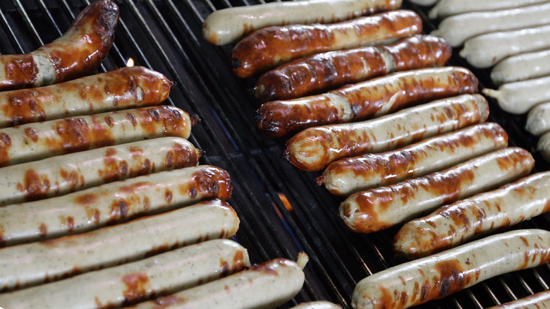 Bratwurst sausages cooking on a grill