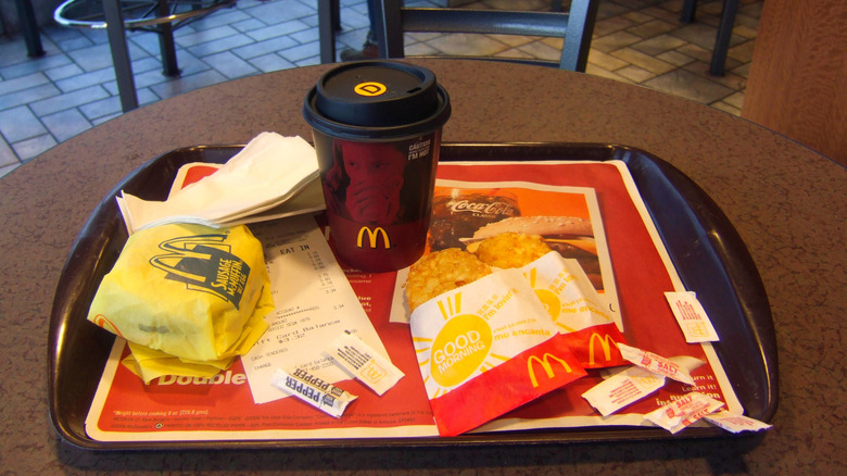 A tray with McDonald's breakfast items sits on a table