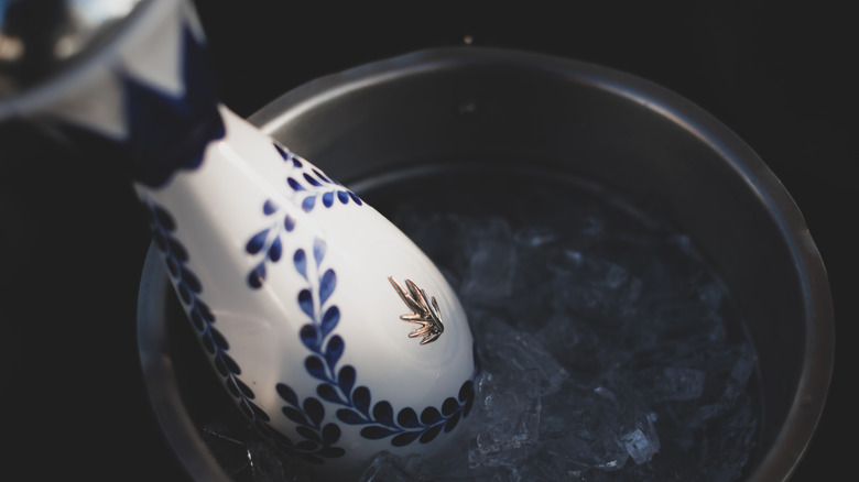 A bottle of Clase Azul Tequila Reposado chills in an ice bucket