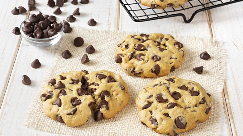 Freshly baked chocolate chip cookies with a side of chocolate chips