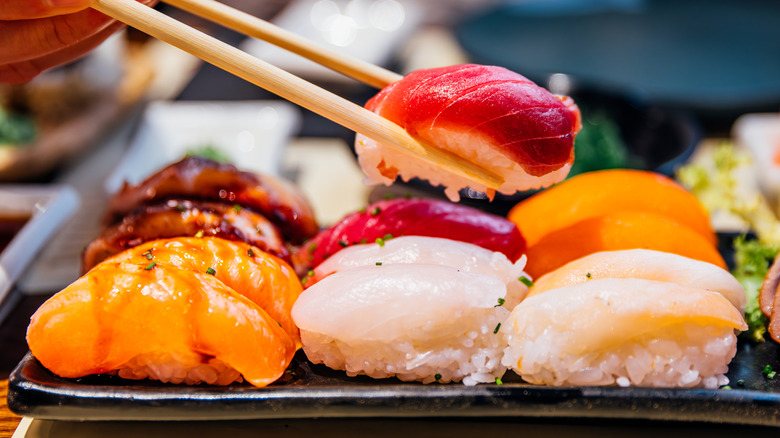 A plate of sushi with chopsticks