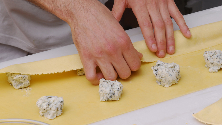 Hand prepare tortelloni pasta with spinach and ricotta filling