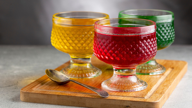 Three colors of fruit gelatin in glass bowls