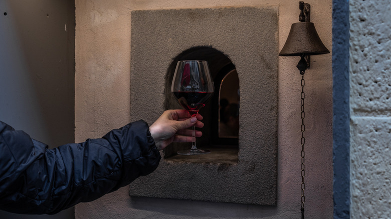 Florence's wine windows are just big enough to pass through a glass of wine.