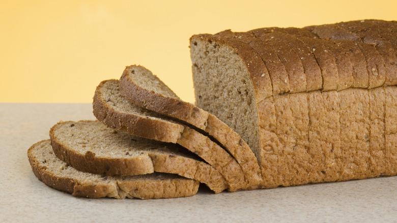 A loaf of sliced bread sitting on a counter.