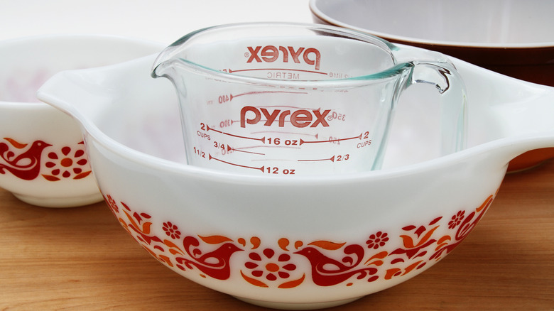 Friendship design Pyrex mixing bowls and a Pyrex clear measuring cup.