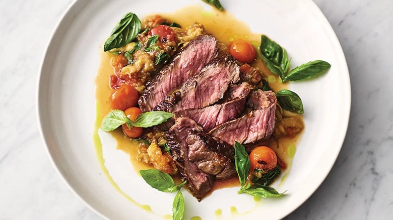 A top-down view of Jamie Oliver's sizzling sirloin on a white plate