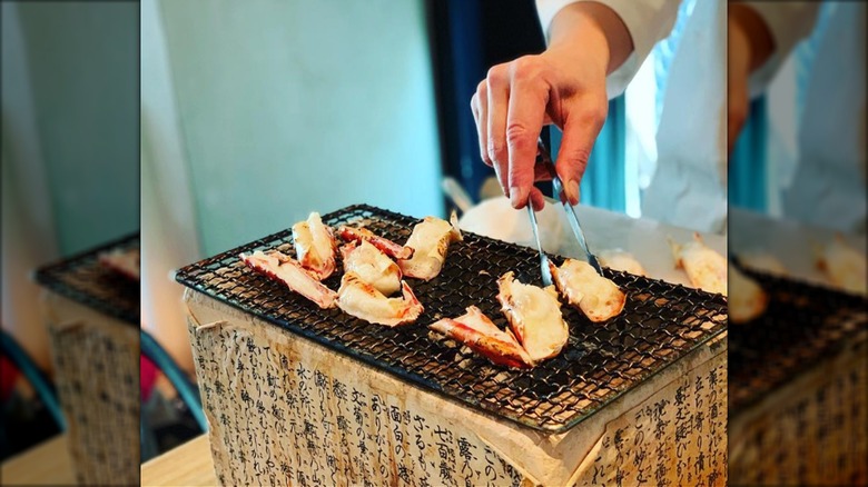 Chef cooking crab at Ginza Kitafuku.