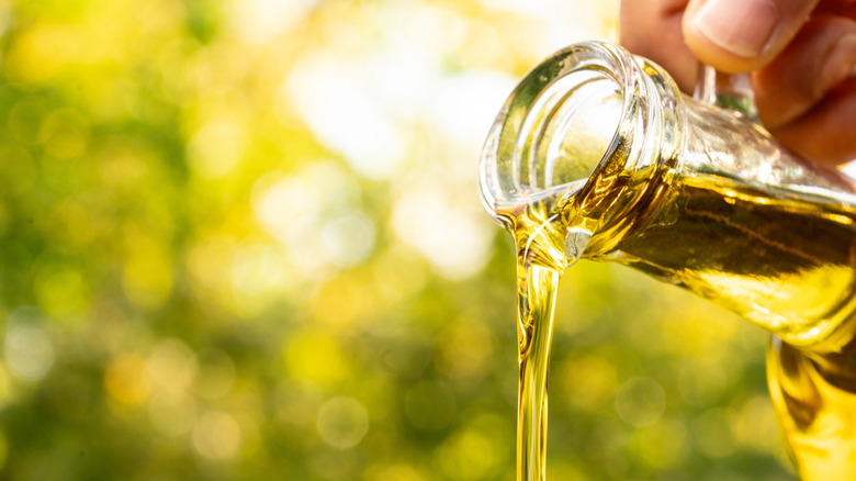 Olive oil poured from bottle