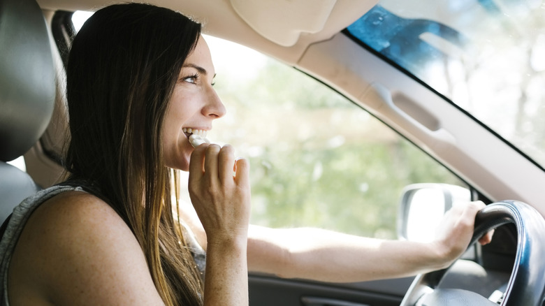 person eating in the car