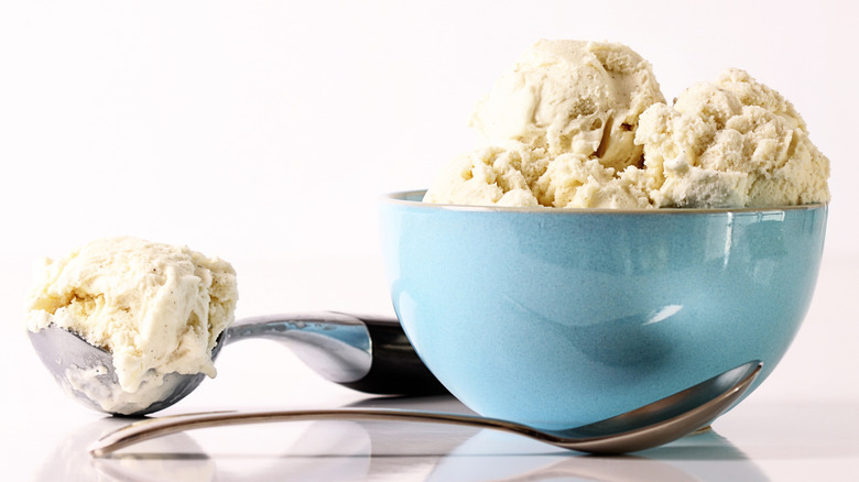 Vanilla ice cream in blue bowl with spoon