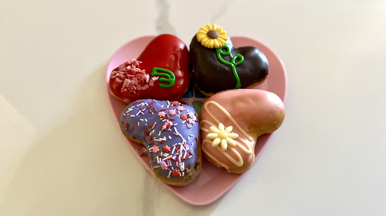 a heart plate with four Krispy Kreme doughnuts