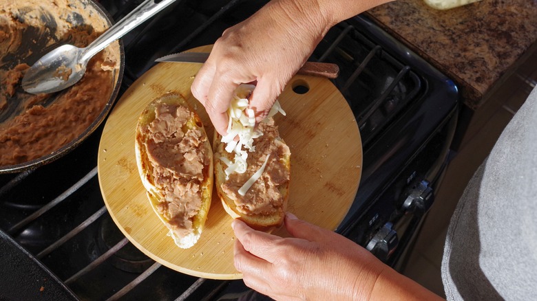 Hands making a mollete sandwich