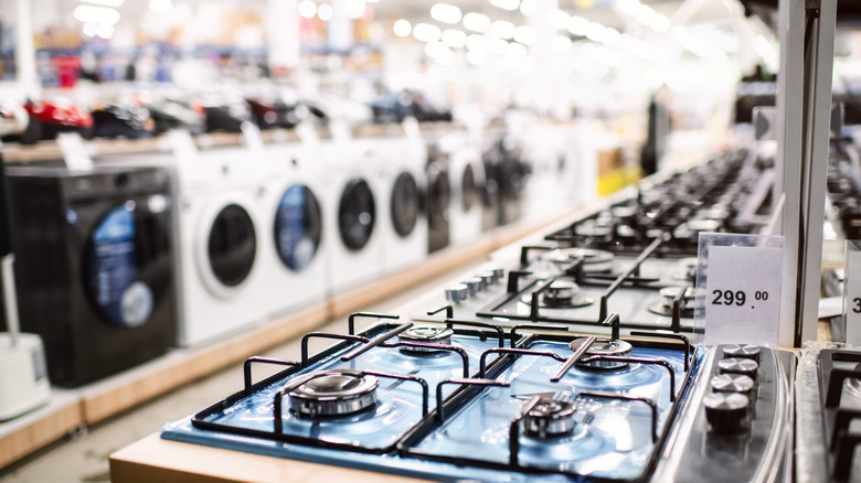 gas stoves for sale in an appliance store.