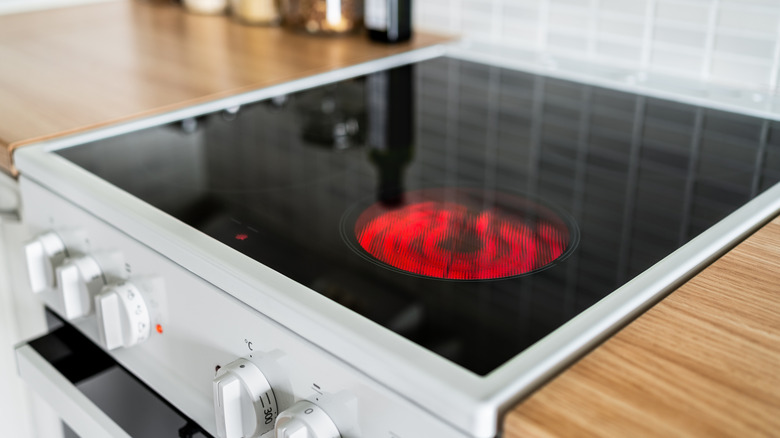 electric stovetop with one glowing burner