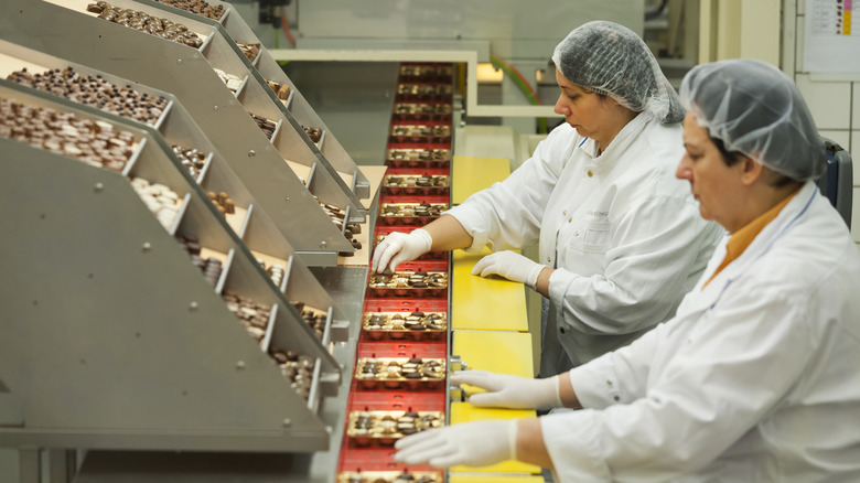 Lindt workers prepare boxes of chocolate