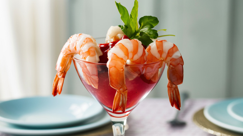 Shrimp and cocktail sauce in glass.