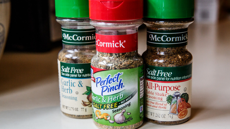 Jars of mixed dried herb shakers with red and green lids