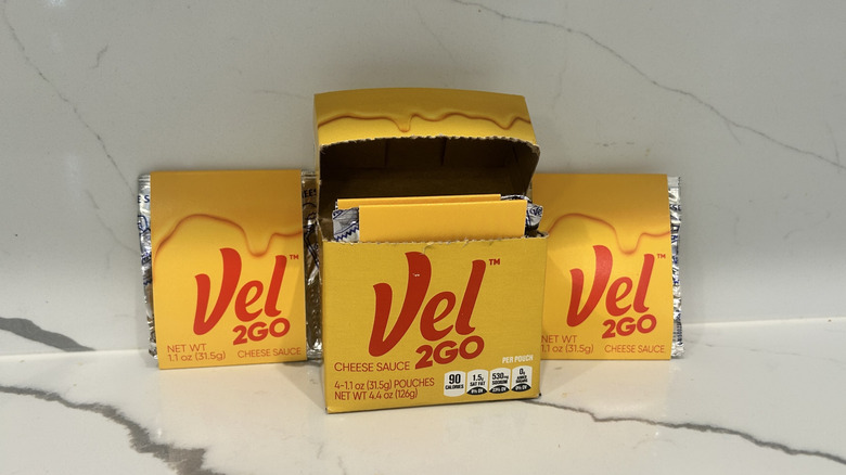 Packs of Velveeta, Vel2Go are spread on a counter