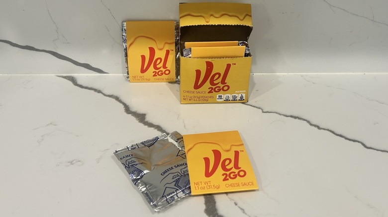 Packs of Velveeta, Vel2Go are spread on a counter