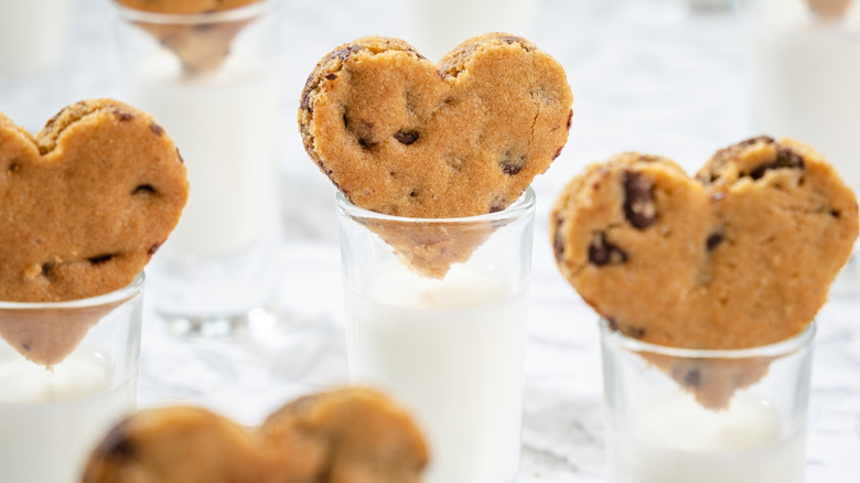 Heart- shaped cookies in shot glasses on a white background