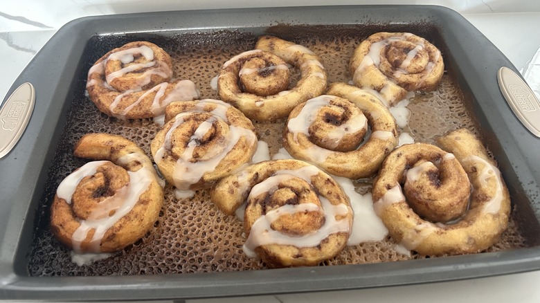 Baked cinnamon rolls in a pan with icing