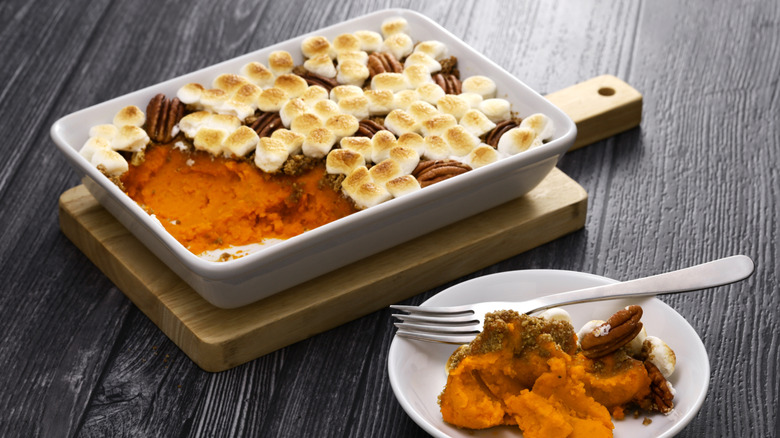 A dish od sweet potato casserole with pecans and toasted marshmallows