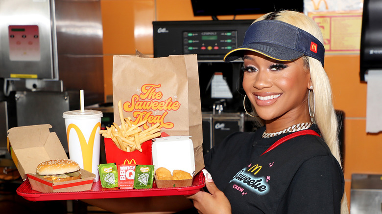 Saweetie in McDonald's uniform with signature meal