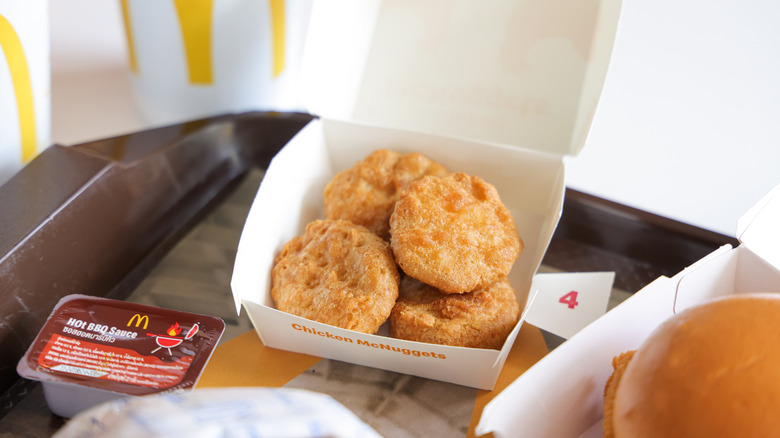 a plate full of McDonald's food with chicken nuggets in center