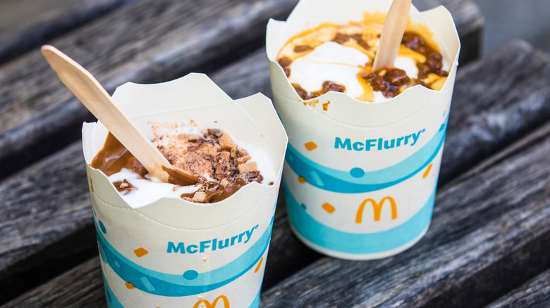 Two white and blue McFlurry cups with specialty McFlurry's within them