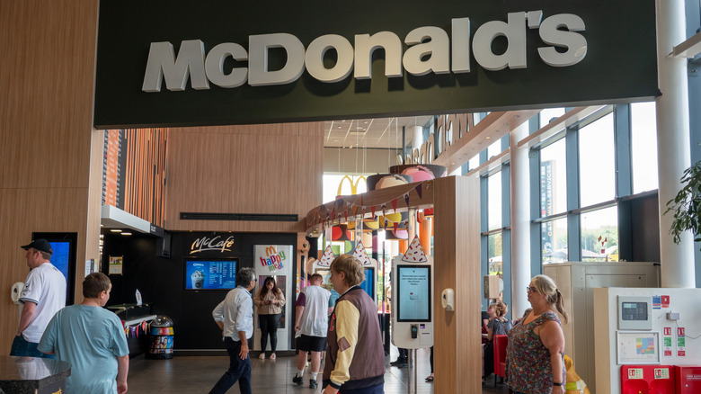 Customers walk through a McDonald's restaurant.