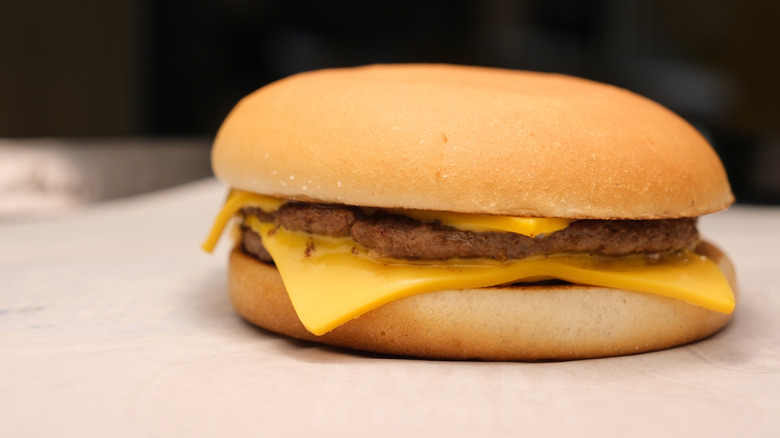 A McDonald's Double Cheeseburger rests on a neutral surface