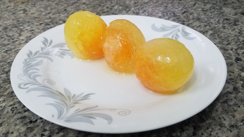 Three frozen egg yolks on a white plate