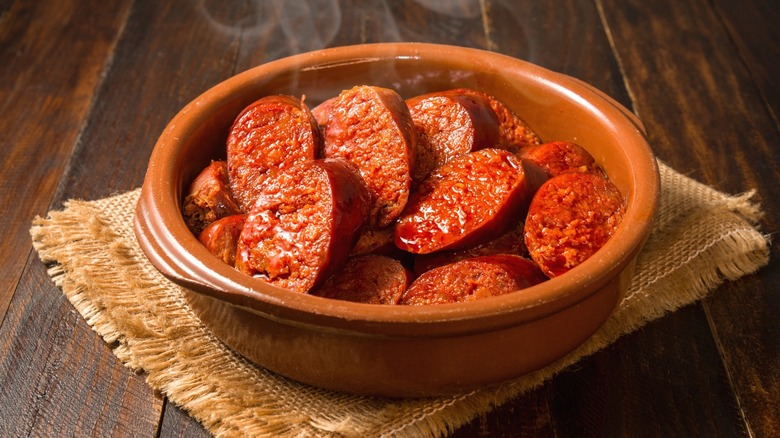 A bowl of Spanish chorizo atop a blanket.