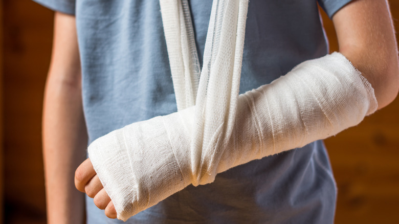 child with a broken arm in a bandage and sling