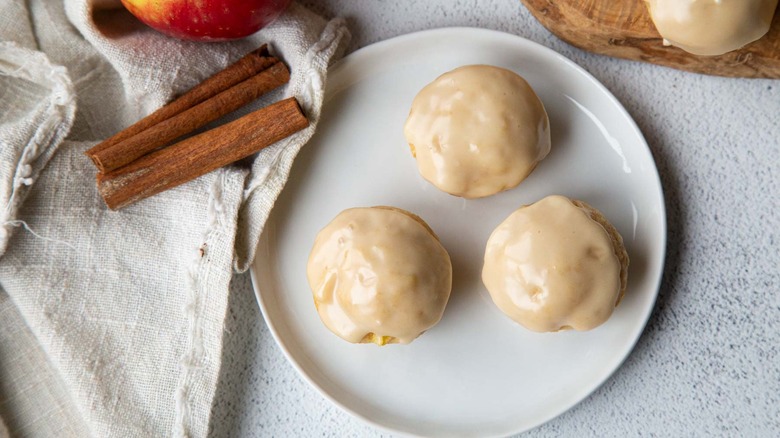 Glazed apple fritters on plate